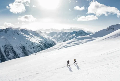 Connect travels with your hobbies, for example hiking through the snow in the alps.