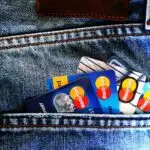 Which are the best credit cards nowadays to travel? Displayed is a jeans pocket with various credit cards.